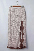 Slit Animal Print Skirt with brown and white spotted pattern, brown lace detail along side slit and hem, lightweight polyester blend fabric