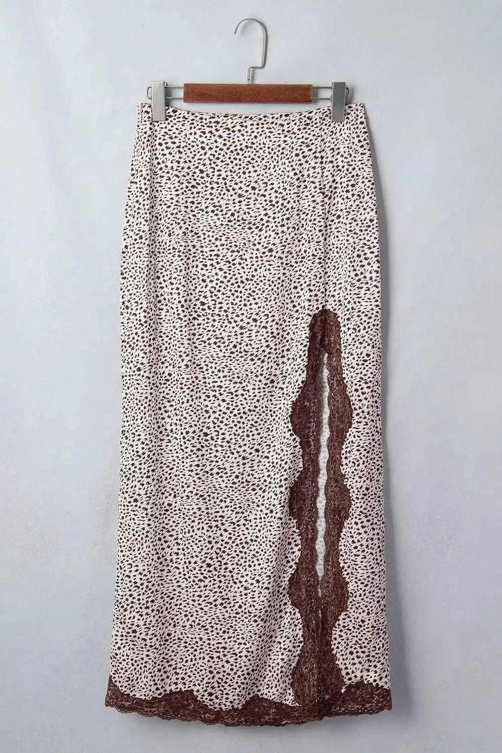 Slit Animal Print Skirt with brown and white spotted pattern, brown lace detail along side slit and hem, lightweight polyester blend fabric