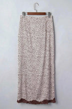 Slit Animal Print Skirt featuring beige fabric with small black animal spots and brown lace trim at hem