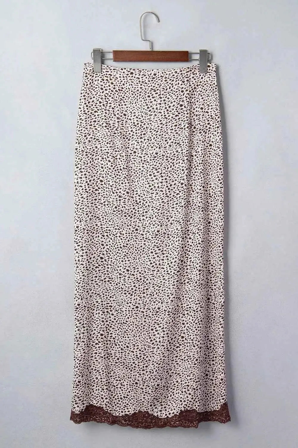 Slit Animal Print Skirt featuring beige fabric with small black animal spots and brown lace trim at hem