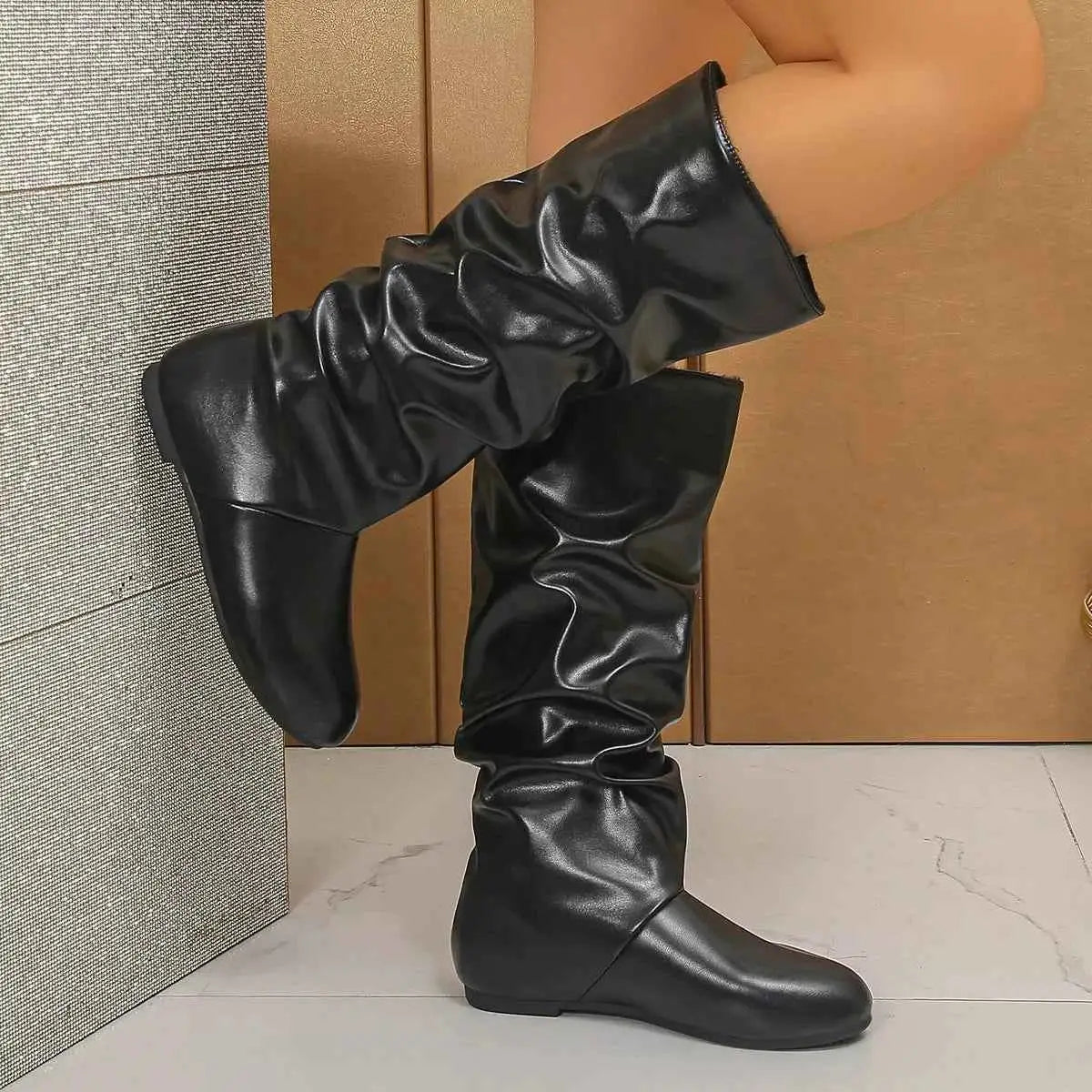 Slouchy Mid-Calf Boots in black PU leather with a slouched design, flat rubber sole, and mid-calf height.