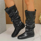 Slouchy Mid-Calf Boots in black PU leather with a wrinkled design and flat rubber soles for comfortable wear.