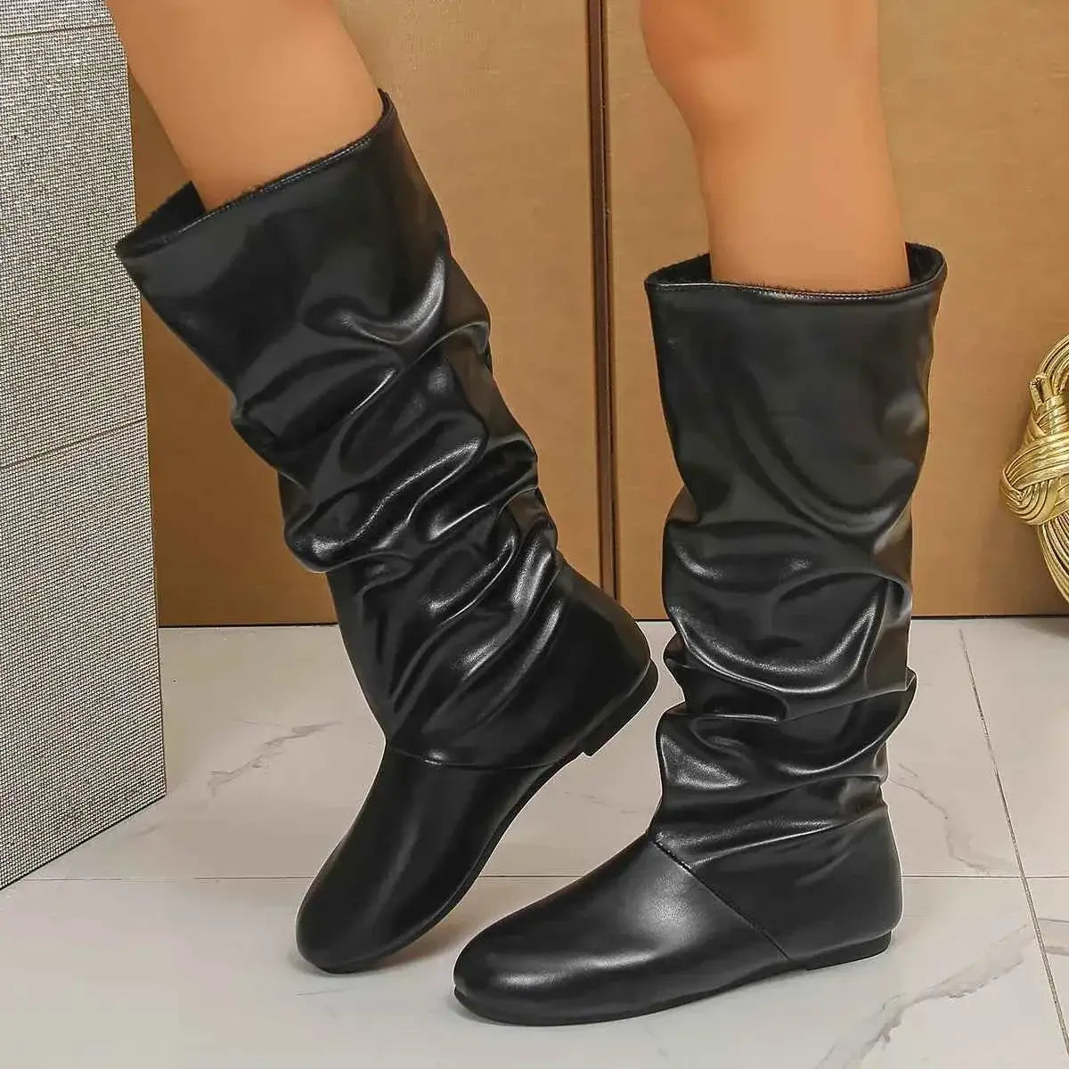 Slouchy Mid-Calf Boots in black PU leather with a wrinkled design and flat rubber soles for comfortable wear.