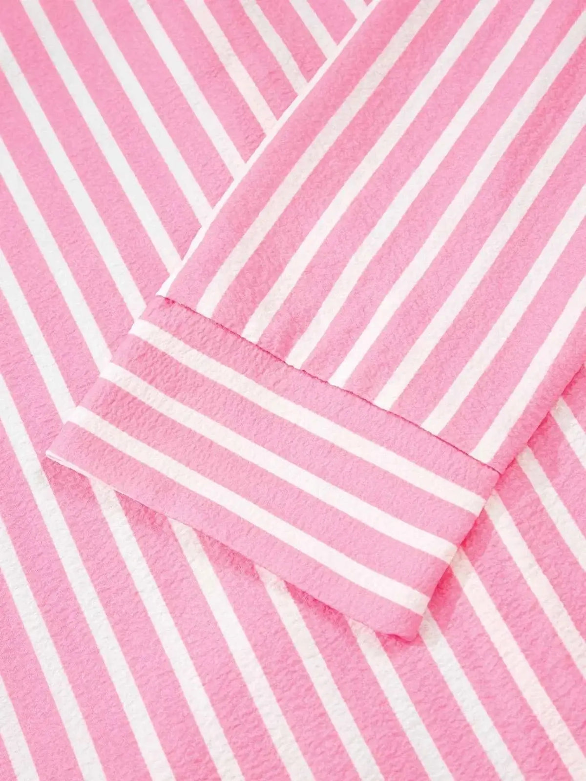 Stripe Buttoned Front long sleeve top in pink and white vertical stripes with a buttoned cuff detail