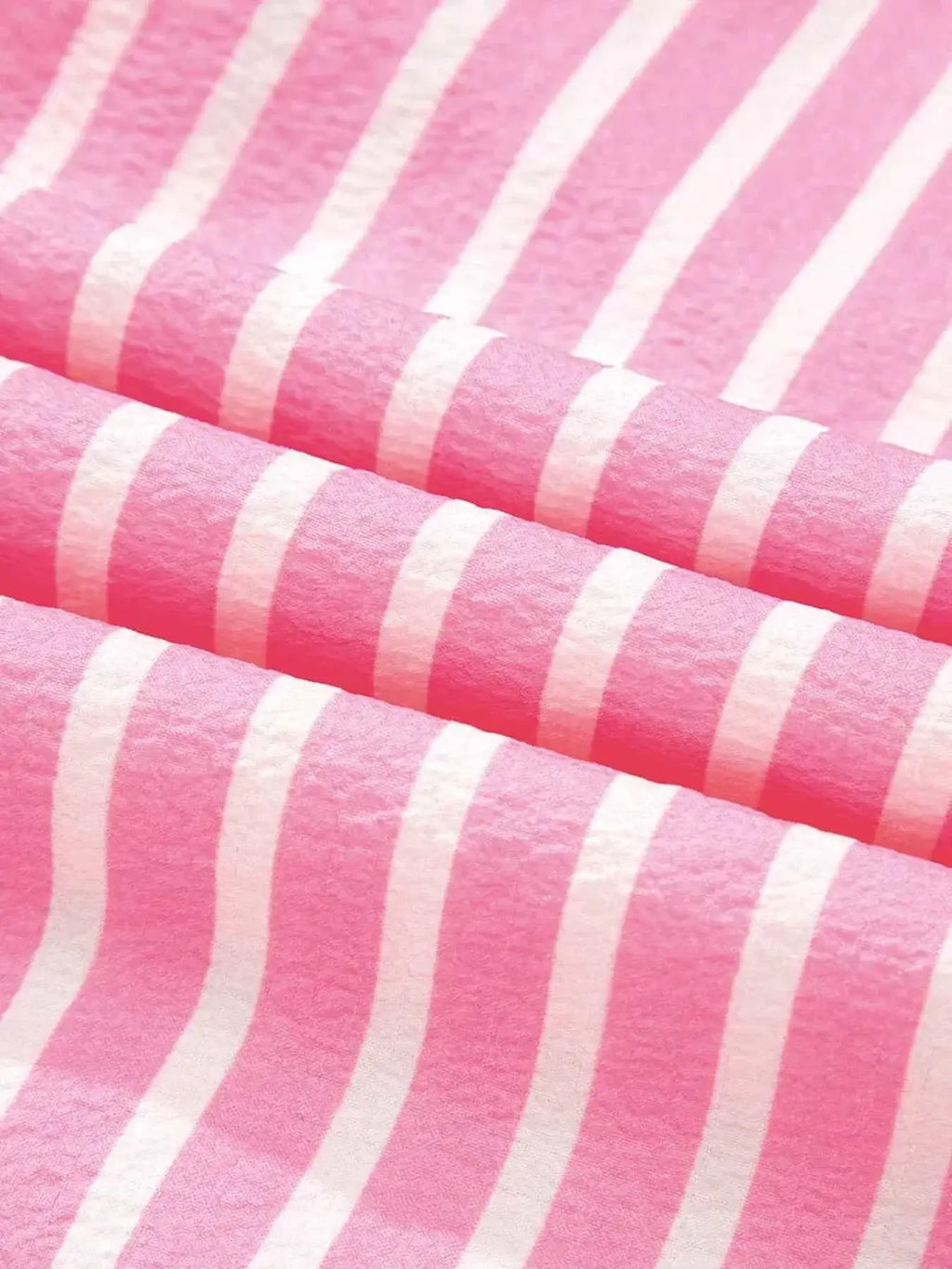 Stripe Buttoned Front fabric with pink and white vertical stripes made of soft polyester material