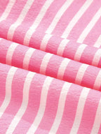 Stripe Buttoned Front fabric with pink and white vertical stripes made of soft polyester material