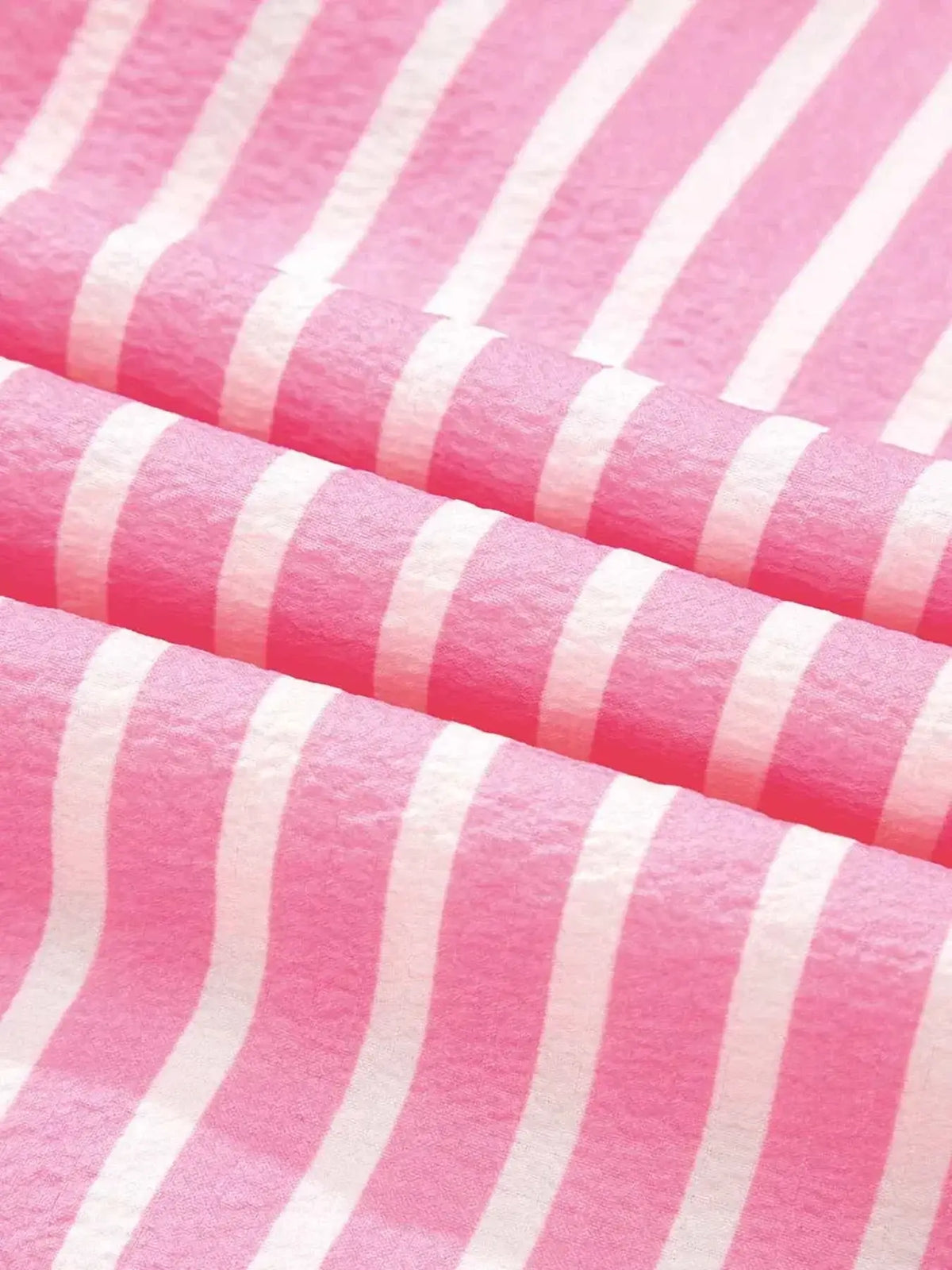 Stripe Buttoned Front fabric with pink and white vertical stripes made of soft polyester material