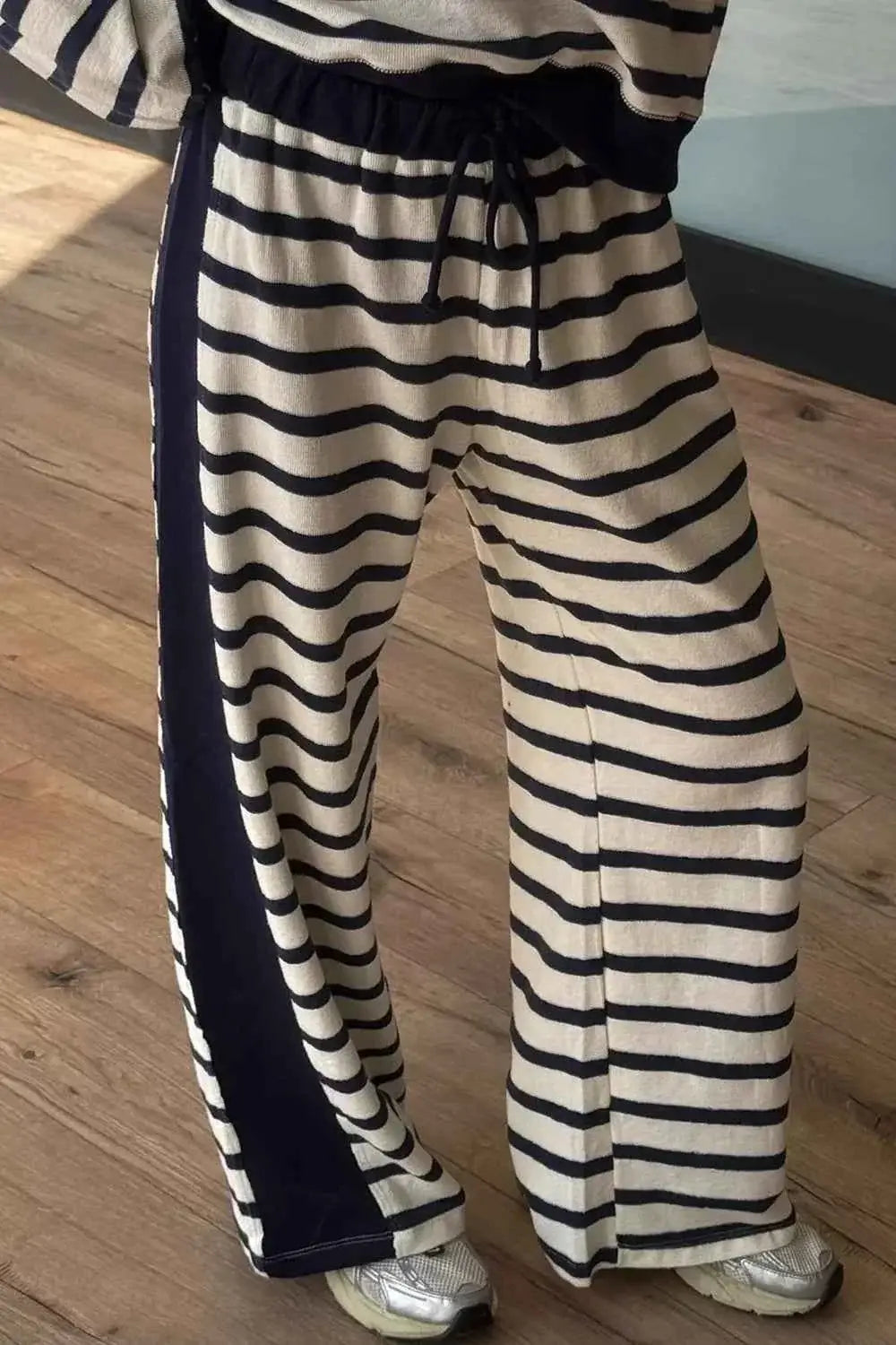 Stripe Relaxed Long Sleeve Top outfit shown with matching wide-leg pants featuring black and white horizontal stripes and a drawstring waist