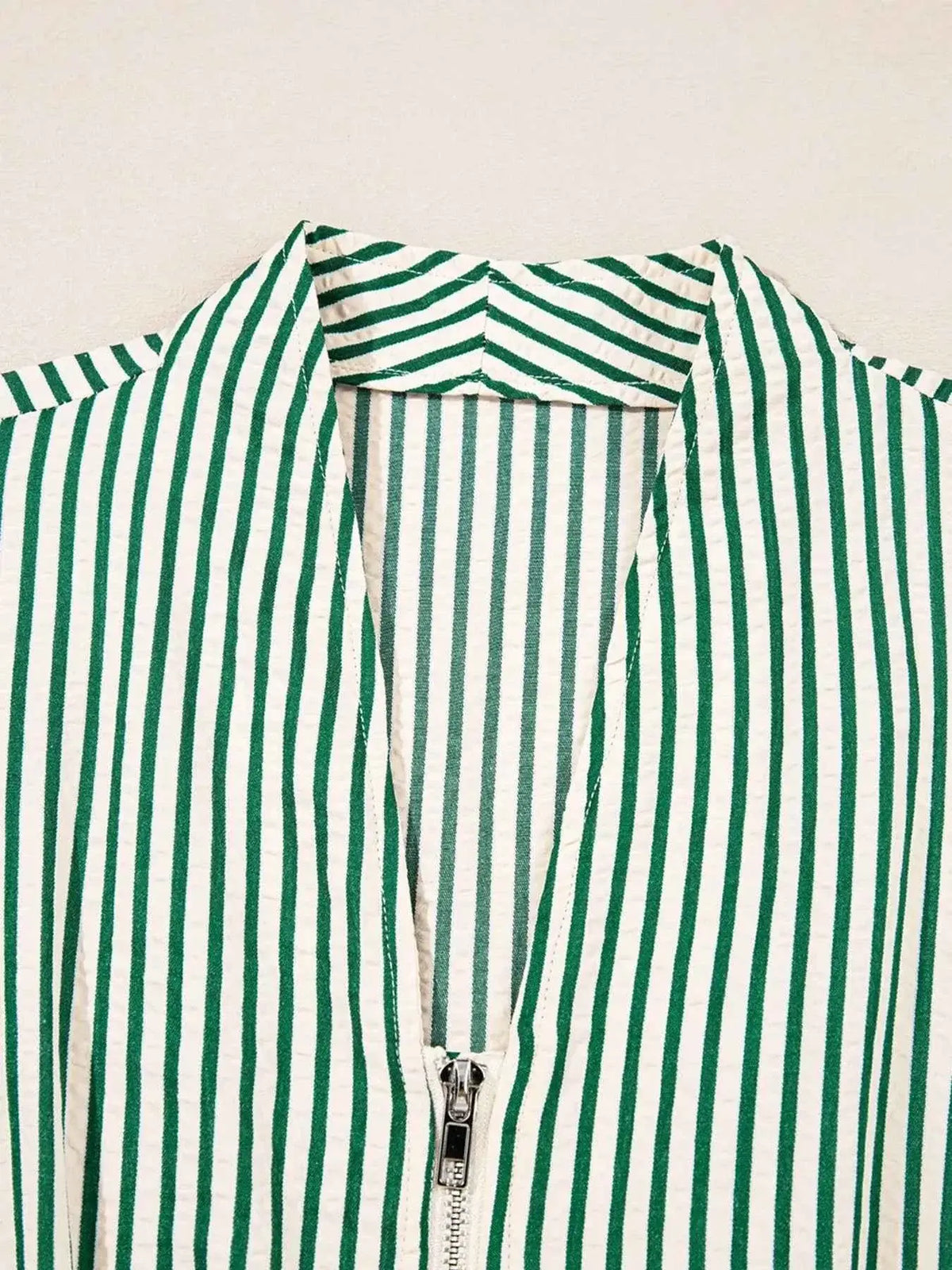 Stripe V Neck midi dress detail showing green and white vertical stripes with zip front and V neckline
