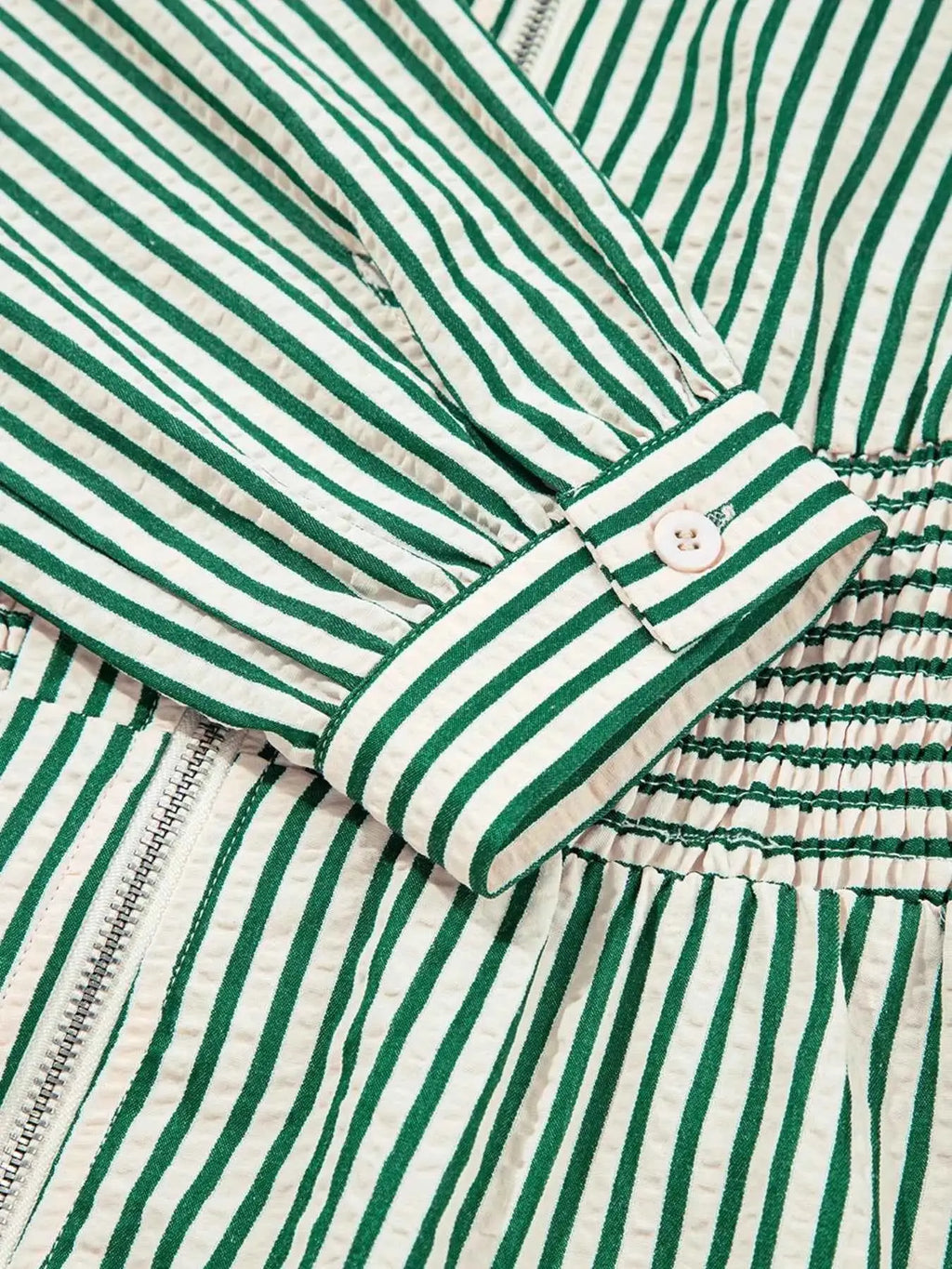 Stripe V Neck dress with green and white vertical stripes, buttoned cuff, zipper front, and cinched smocked waist detail
