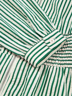 Stripe V Neck dress with green and white vertical stripes, buttoned cuff, zipper front, and cinched smocked waist detail