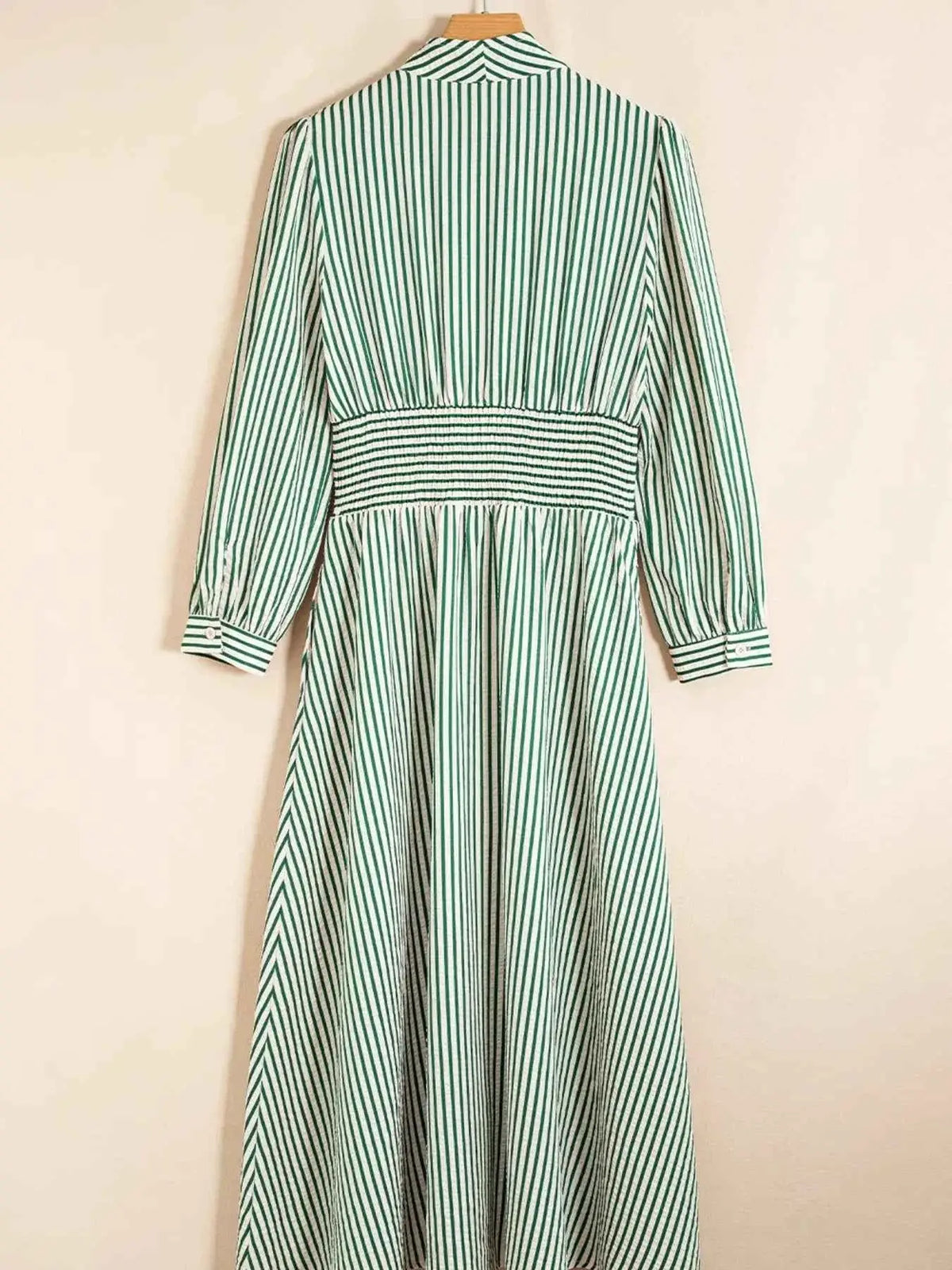 Stripe V Neck midi dress with green and white vertical stripes, cinched waist, long sleeves, and zip front detail