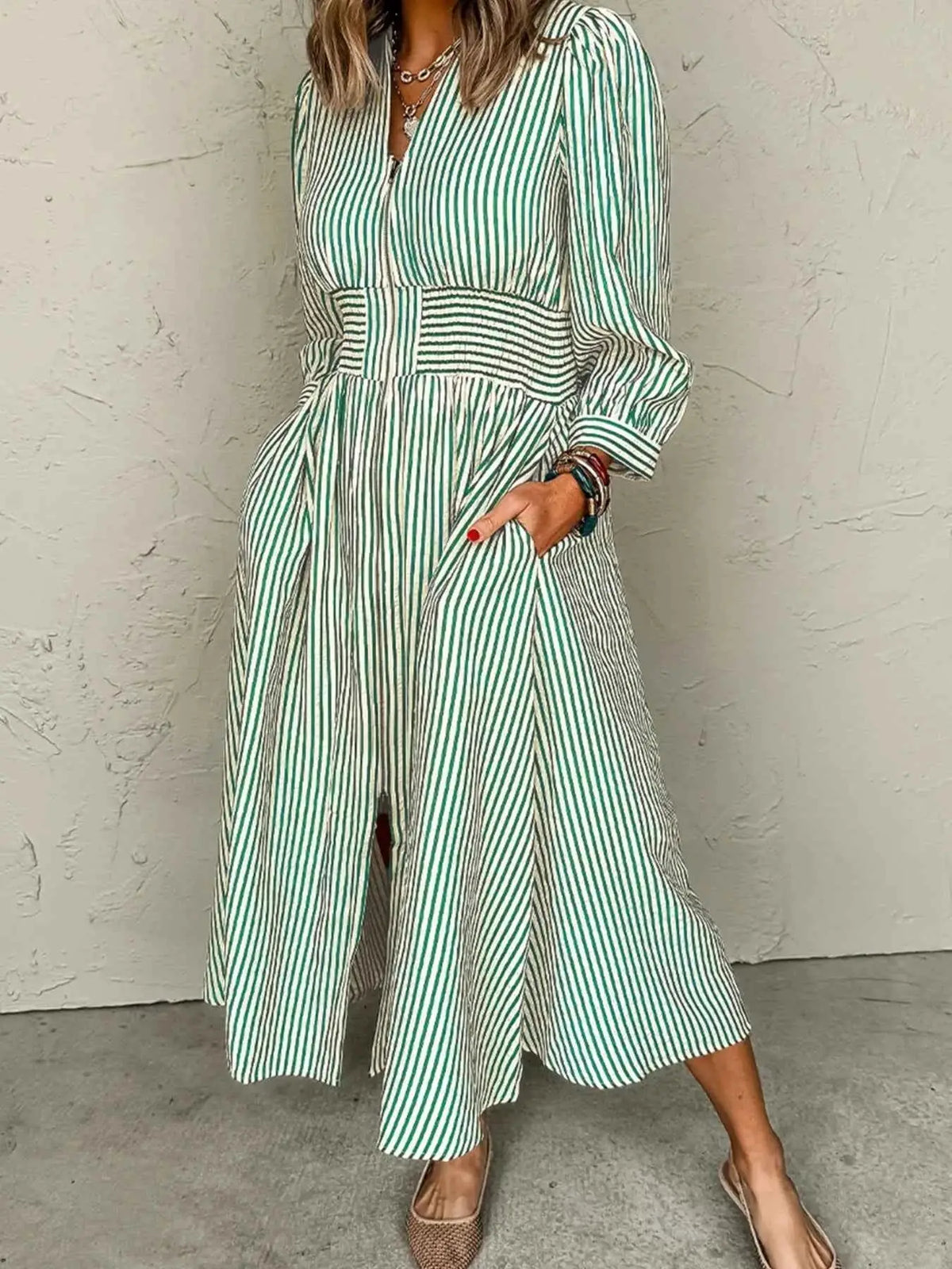Stripe V Neck midi dress with green and white vertical stripes, zip front, cinched high waist, long sleeves, and pockets