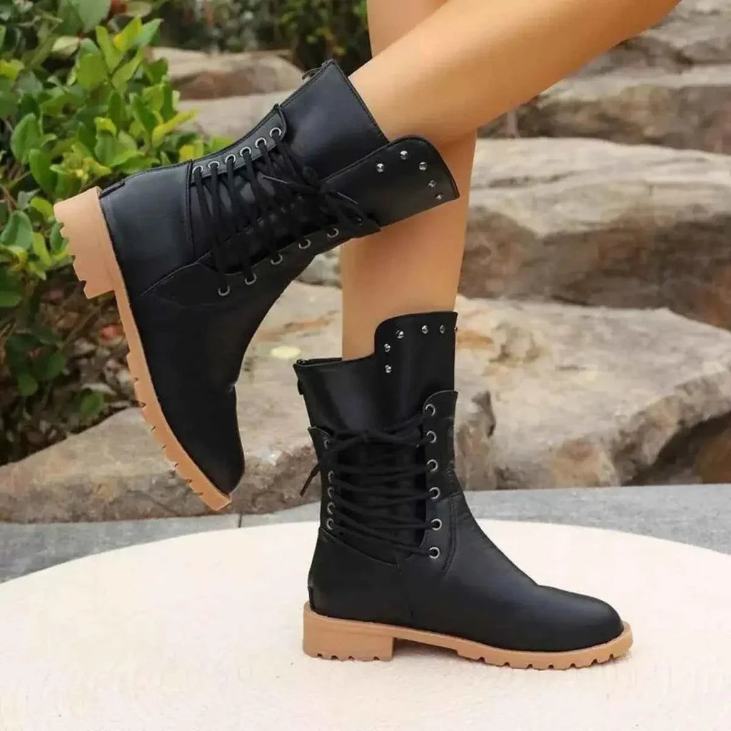 Studded Lace-Up Boots in black PU leather with mid heels, metal eyelets, and decorative studs on the collar with tan rubber soles.