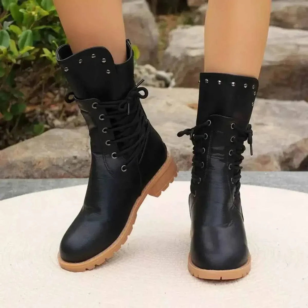 Studded Lace-Up Boots in black PU leather with silver studs, lace-up front, and tan rubber mid-height soles.
