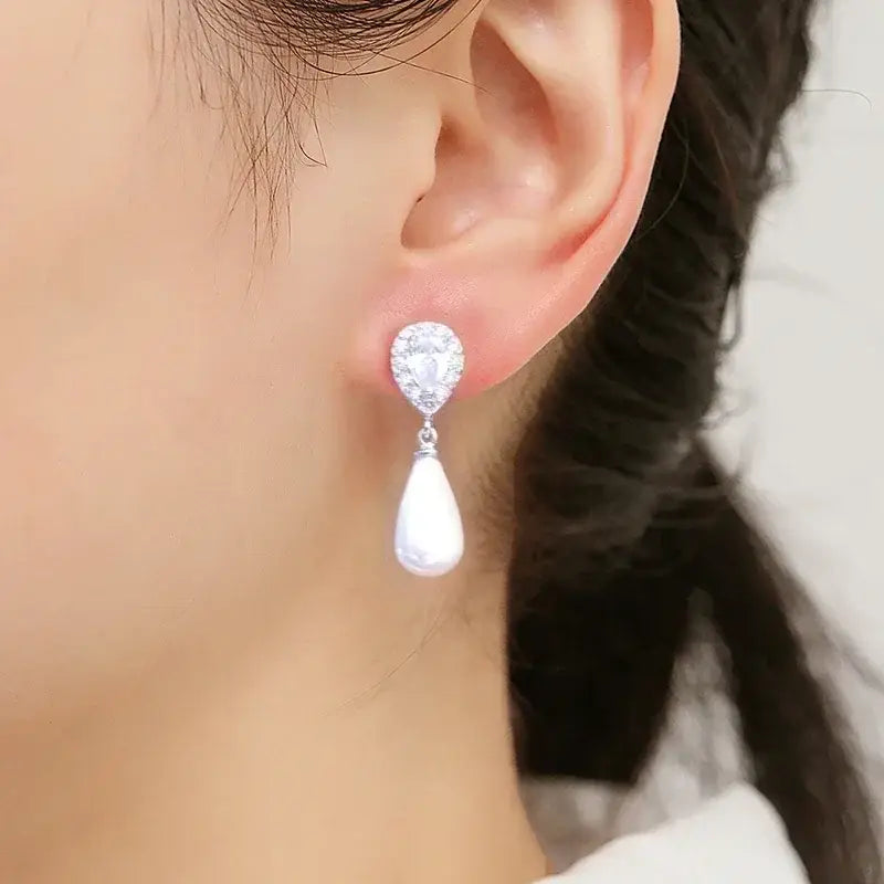 Stylish Teardrop Earrings featuring white imitation pearl dangles with clear cubic zirconia on silver-tone metal