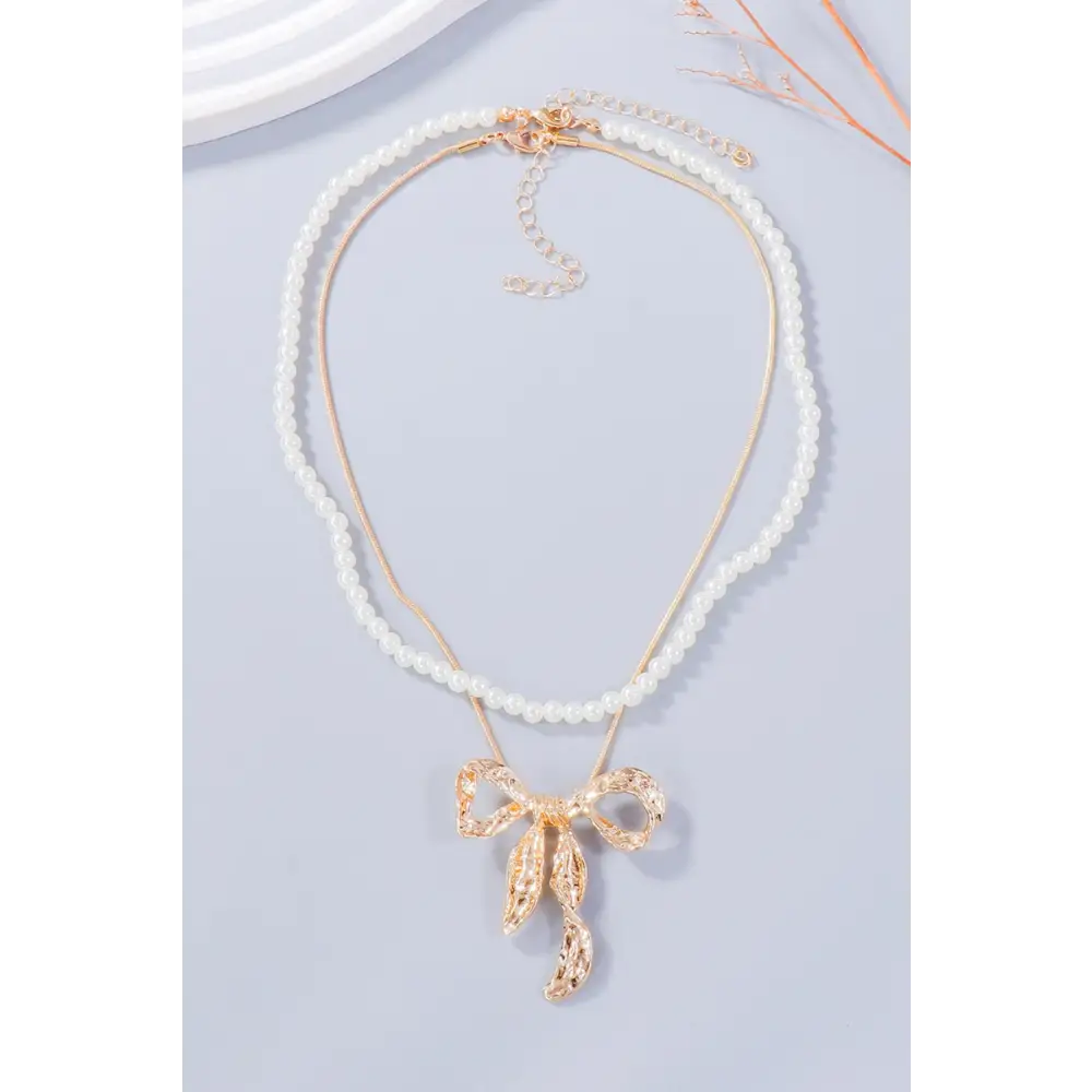 Luxury fashion for woman bow necklace and earring jewelry set $13.99 2-piece synthetic pearl, alloy care to maintain