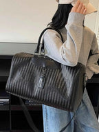 Textured Leather Travel Bag in black PU leather with a woven pattern, featuring handles and a detachable shoulder strap