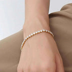 Titanium Steel Bracelet with gold plating and clear round stones in a continuous pattern around the wrist