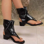 Black PU leather Toe Post Block Heels Sandals with shiny finish, front zipper detail, and low block heel design.
