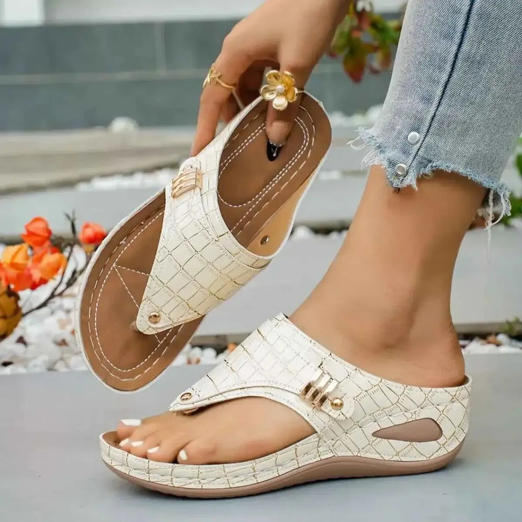 Toe Post Wedge Sandals in cream-colored textured PU leather with mid wedge heel and decorative buckle detail