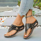 Toe Post Wedge Sandals in black PU leather with crocodile pattern, featuring mid heels and open toe design with ankle chain