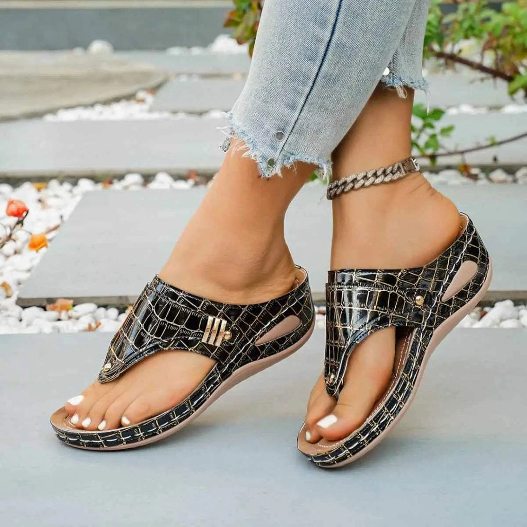 Toe Post Wedge Sandals in black faux crocodile PU leather with mid heel rubber sole and gold accent detail