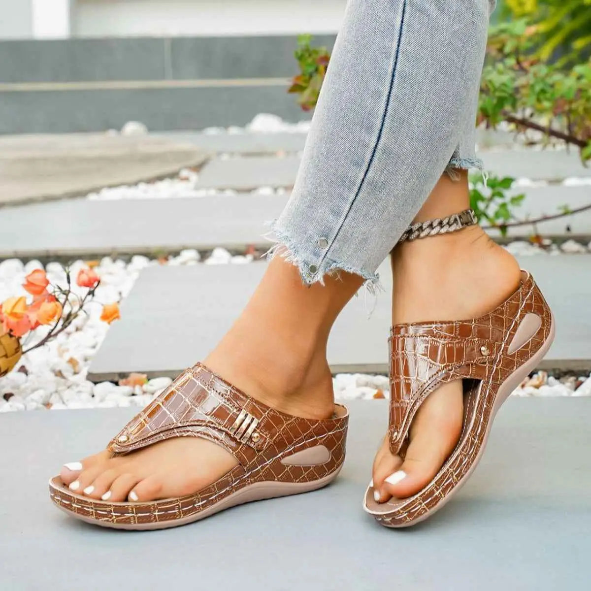 Brown PU leather Toe Post Wedge Sandals with mid heel and crocodile pattern paired with blue jeans and ankle bracelet