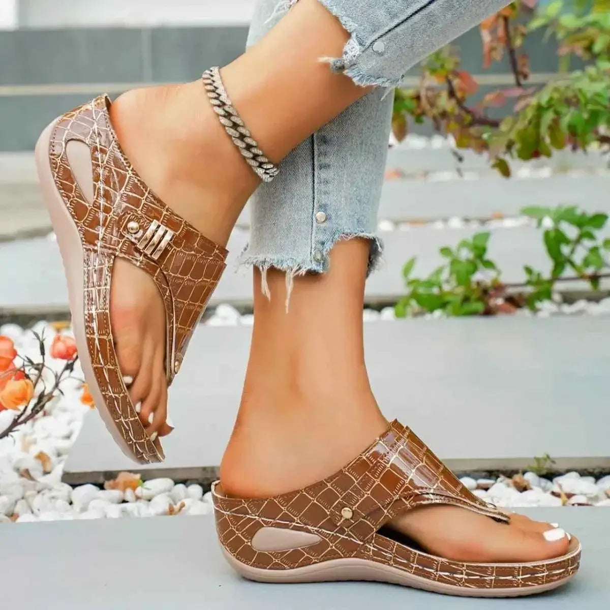 Toe Post Wedge Sandals in brown PU leather with a textured pattern and mid heels, worn with ankle bracelet and casual jeans