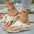 Toe Post Wedge Sandals in cream croc-embossed PU leather with mid wedge heels and gold-tone accents worn with ankle chain and rolled denim jeans