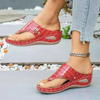 Toe Post Wedge Sandals in shiny red PU leather with crocodile pattern and mid heel, worn with ankle bracelet