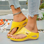 Yellow faux croc leather Toe Post Wedge Sandals with mid-height heels and gold-tone hardware details worn with light denim jeans