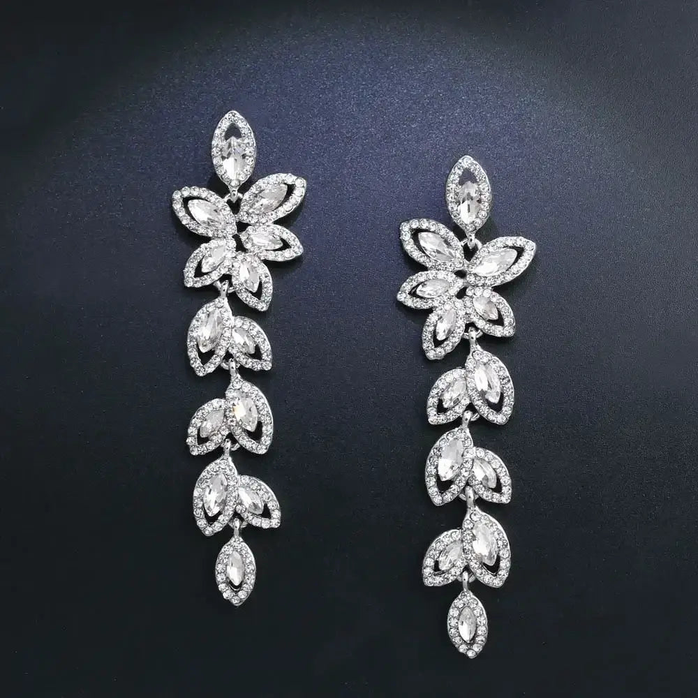 TREAZY Fashion Crystal Earrings silver color bridal drop earrings with leaf-shaped crystal design on black background