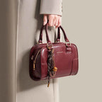 Vintage Style Barrel Crossbody Bag in burgundy PU leather with gold hardware and decorative tassel detail