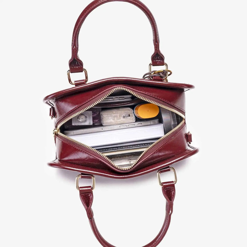 Vintage Style Barrel Crossbody Bag in burgundy PU leather with gold hardware and dual handles, medium size, opened to show contents
