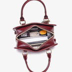 Vintage Style Barrel Crossbody Bag in burgundy PU leather with gold hardware and dual handles, medium size, opened to show contents
