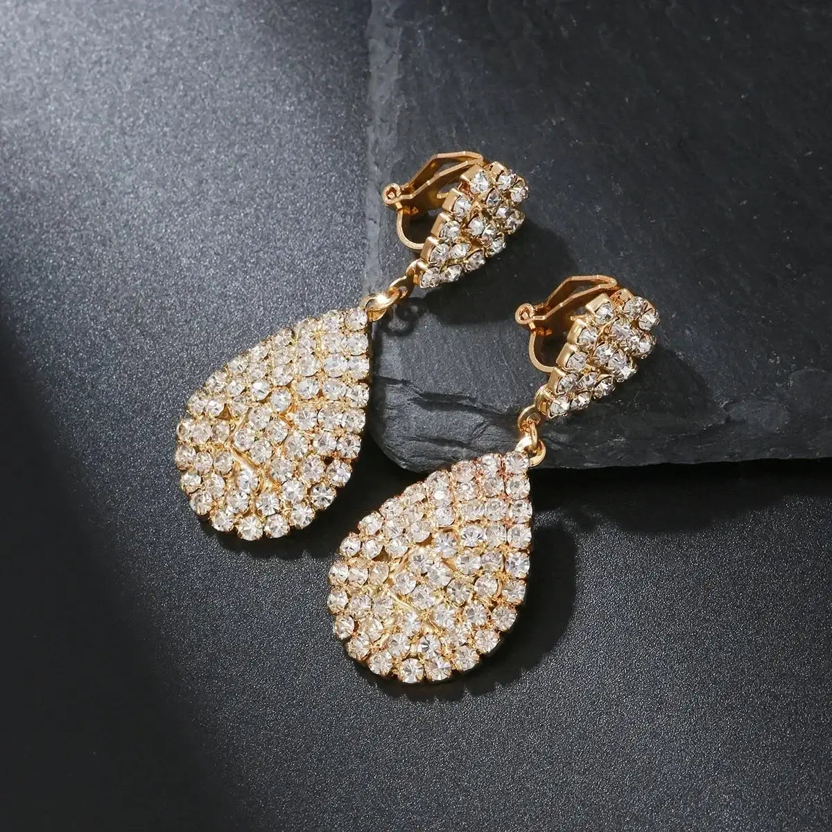 Water Drop Clip On Earrings with gold-tone metal and sparkling cubic zirconia crystals in a teardrop dangle design