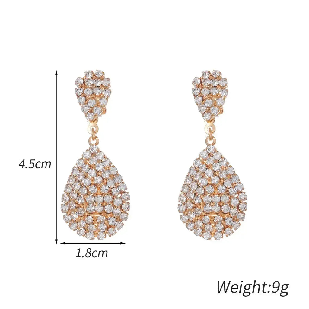Water Drop Clip On Earrings in gold-tone with cubic zirconia crystals forming a geometric teardrop dangle design