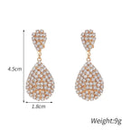 Water Drop Clip On Earrings in gold-tone with cubic zirconia crystals forming a geometric teardrop dangle design
