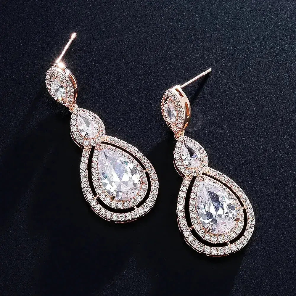 Long dangle Water Drop Cubic Zircon earrings in silver with rose gold and clear stones sparkling around teardrop shapes