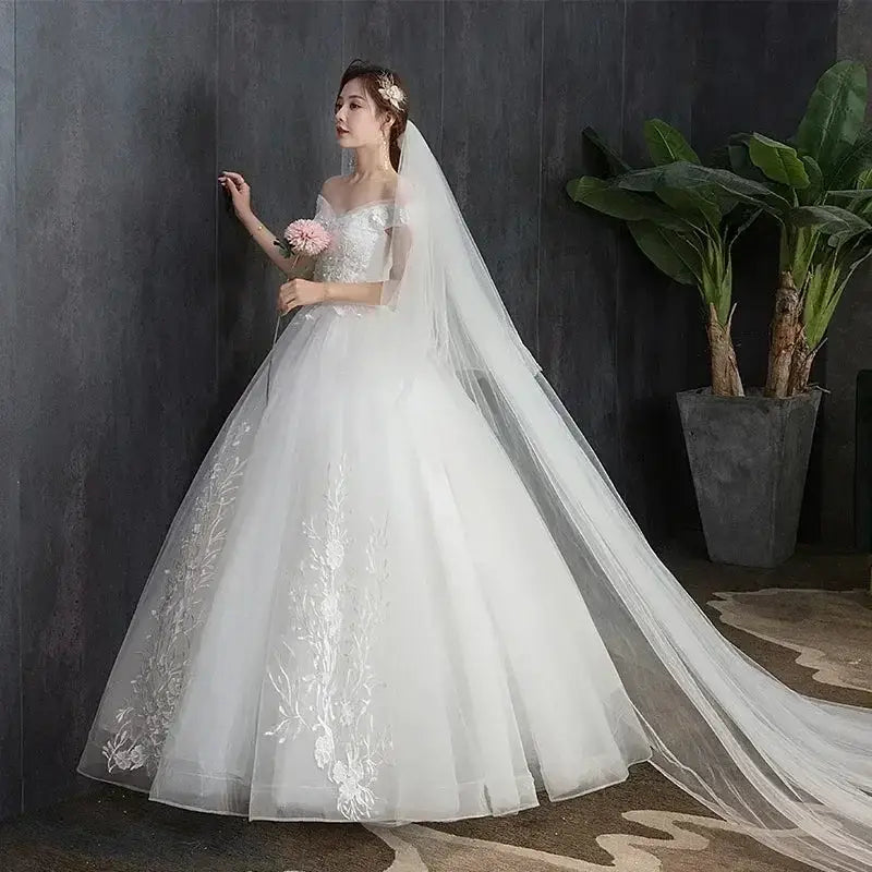 Wedding Dress 2024 white ball gown with lace applique, off-the-shoulder short sleeves, V-neckline, and long veil