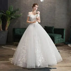 Wedding Dress 2024 white ball gown with V-neckline, off-the-shoulder short sleeves, luxury lace appliques, and embroidered floral pattern
