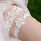 Wedding Garter Belt featuring white lace with floral patterns and pearl crystal embellishments on thigh
