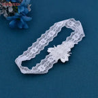 White lace Wedding Garter Belt featuring a delicate flower applique with pearl and crystal bead accents on elastic lace band