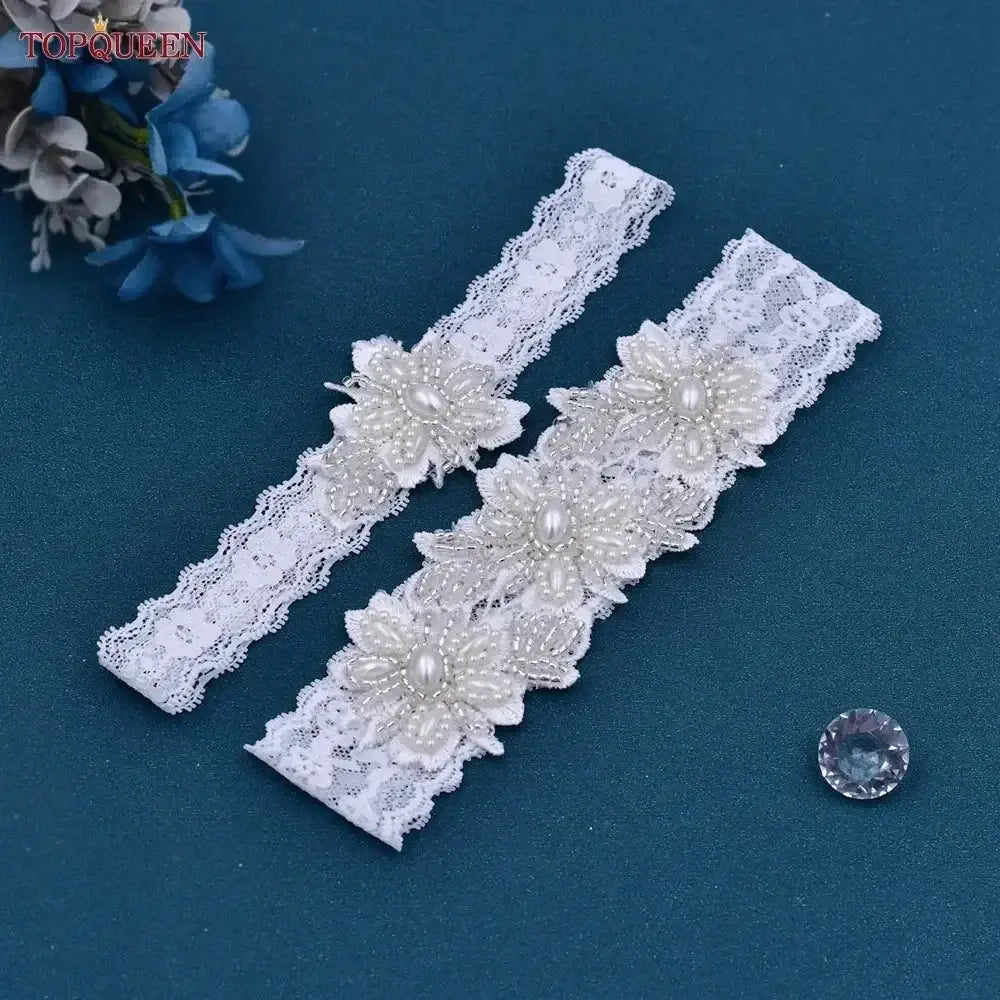 Wedding Garter Belt set in white lace with pearl and crystal floral embellishments, featuring delicate scalloped edges