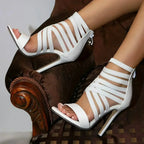 White Lace-Up Heels with slim stiletto heel and multiple horizontal straps in smooth white leather with back zipper closure