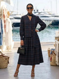 Black structured leather handbag with gold-tone hardware from women’s summer set IBIZA CALA JONDAL by BYMANYC New York