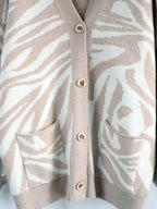 Zebra Print Button Up cardigan in beige and white with a buttoned front and two front pockets made of soft knit fabric