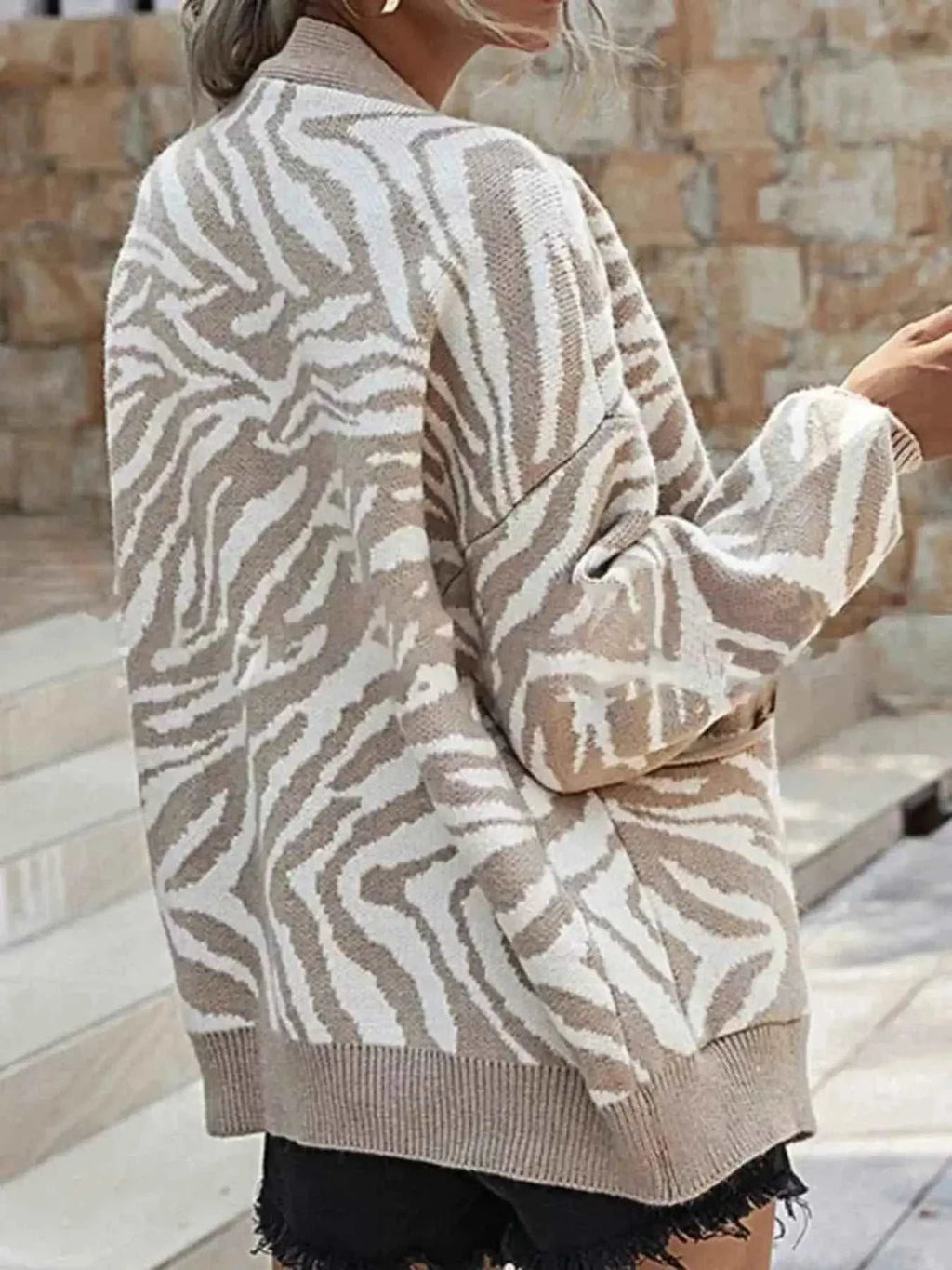 Zebra Print Button Up cardigan in beige and white with long sleeves, ribbed cuffs and hem, knitted polyester material