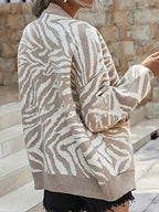 Zebra Print Button Up cardigan in beige and white with long sleeves, ribbed cuffs and hem, knitted polyester material